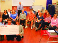 Community choir presents cheque to cancer treatment centre