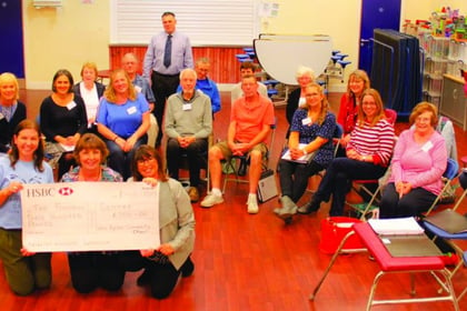 Community choir presents cheque to cancer treatment centre