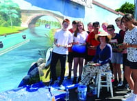 Students help create vibrant mural at station