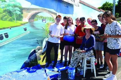 Students help create vibrant mural at station