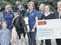 Nursery’s donation provides special saddle for therapy horse