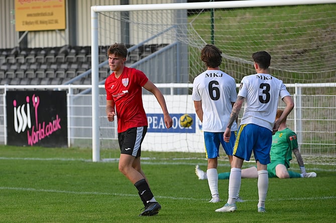 Knaphill, red and black, get on to the scoresheet during the friendly against Westfield at Woking Park on Tuesday last week    