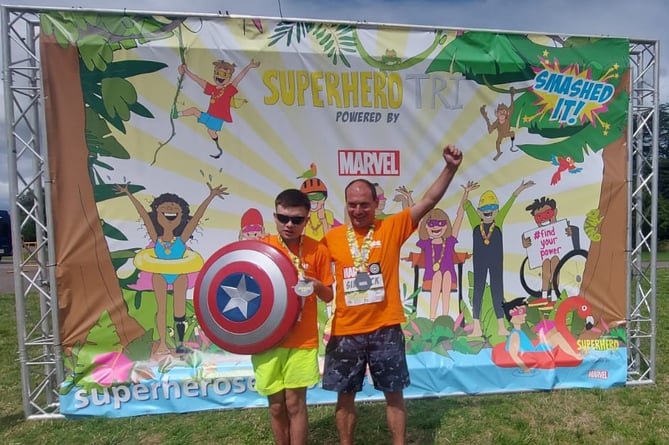 Lee Roake and his father Anthony Roake after completing Superhero Tri at Dorney Lake