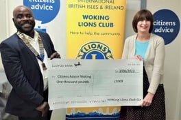 Woking Lions’ president Reg Fianu presents a cheque to Lorraine Buchanan of Citizens Advice Woking
