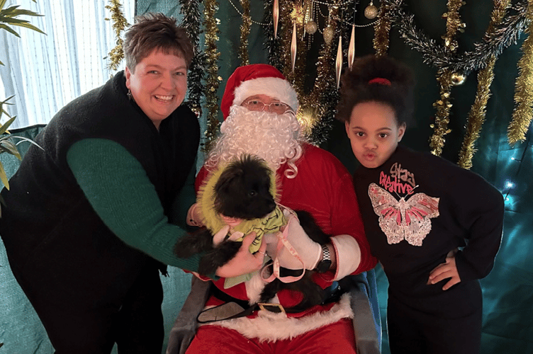 Dior, brought along to Santa Paws by Dawn Duruibe and daughter Florence, hopes for a big present