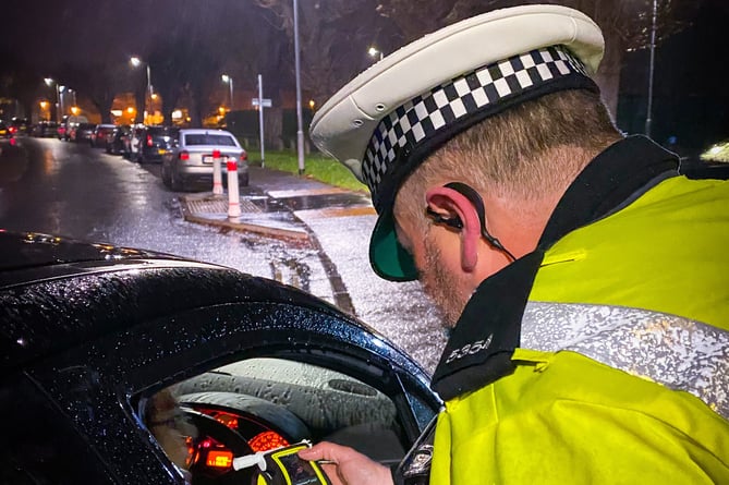 Police conducting a roadside breath test.