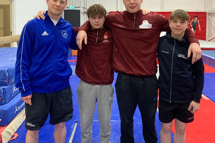 Woking Gymnastics Club coach Craig Woodhams with Josh, Oli and Ben Porter, April 2024.