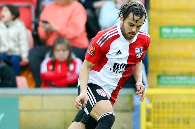 Woking defender Dion Kelly-Evans has signed a new contract