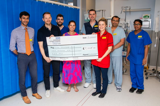 Mike Willoughby and his family present a cheque to the ICU team