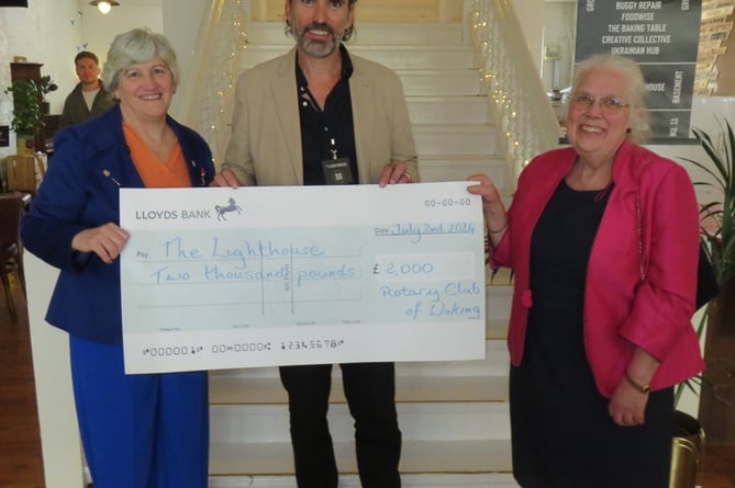 Eric Jespersen of the The Lighthouse receiving a cheque from Carol and Sue