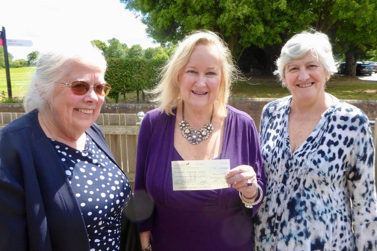 Tania Cantoni from Woking & Sam Beare Hospice receiving a cheque from Carol and Sue