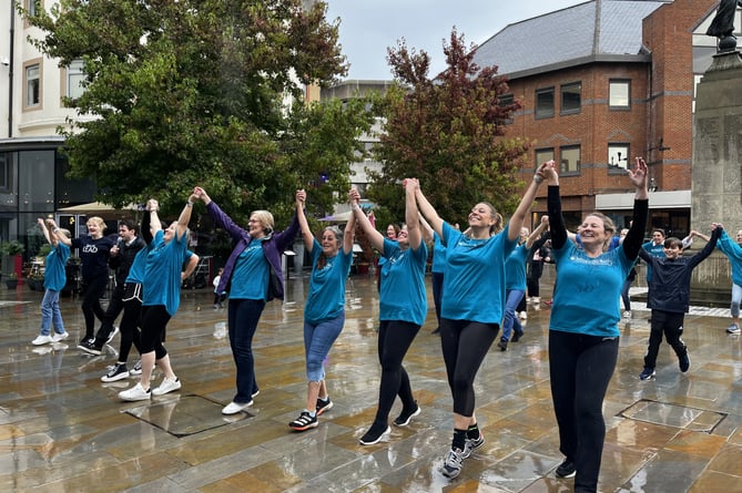 A flash mob braves the weather  to launch Woking & Sam Beare Hospice's appeal