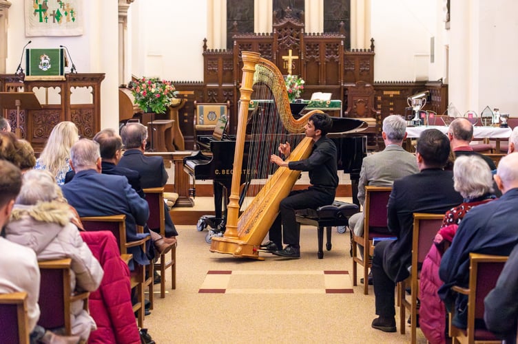 Jamaal Kashim playing the harp